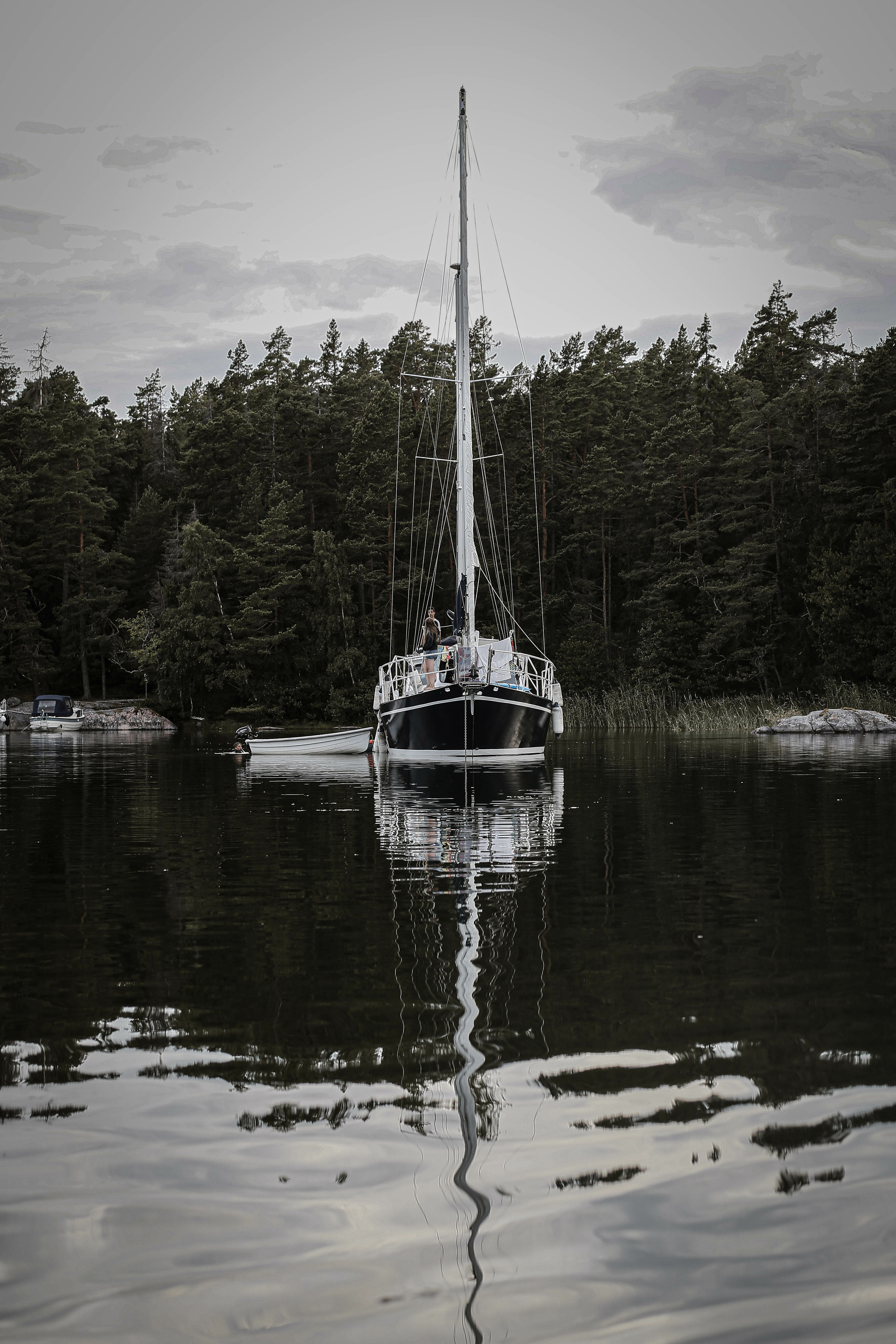 Ein Segelboot, das auf einem spiegelglatten Meer im Stockholmer Schärengarten liegt